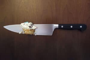 Knife cutting a cupcake
