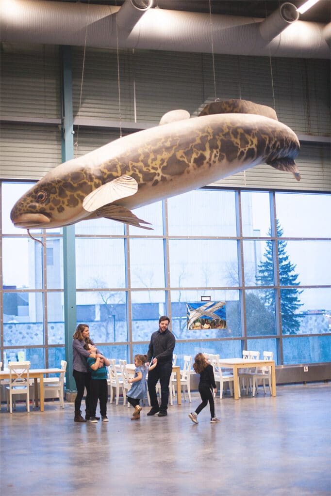 A family standing under a giant lake trout at the Great Lakes Aquarium in Duluth, Minnesota