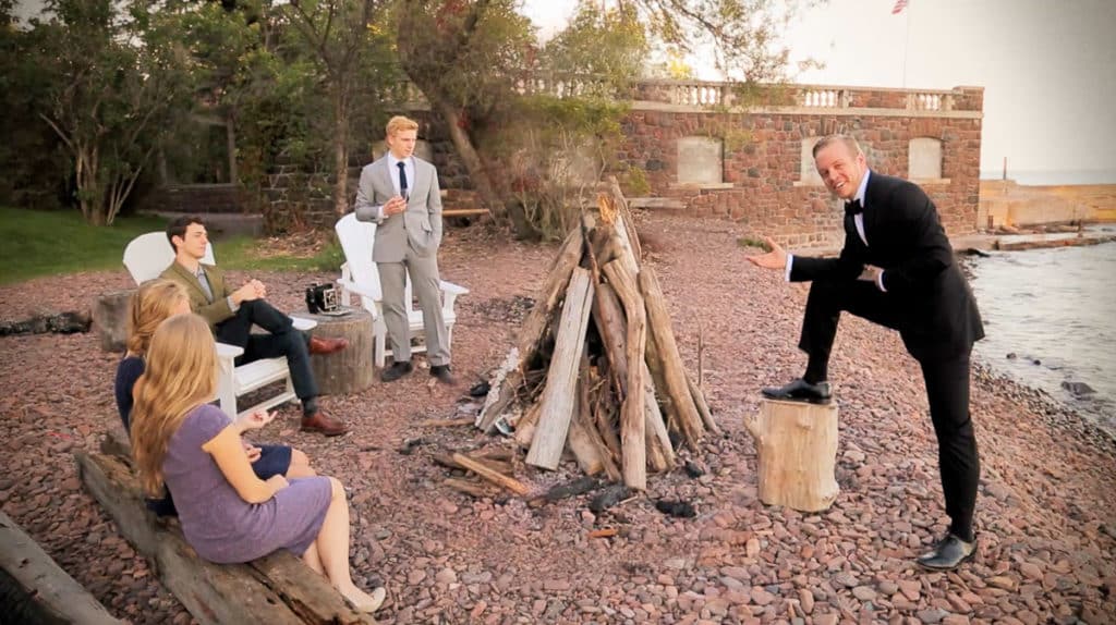 Group of friends sitting around a bonfire at the Glensheen Mansion in Duluth Minnesota