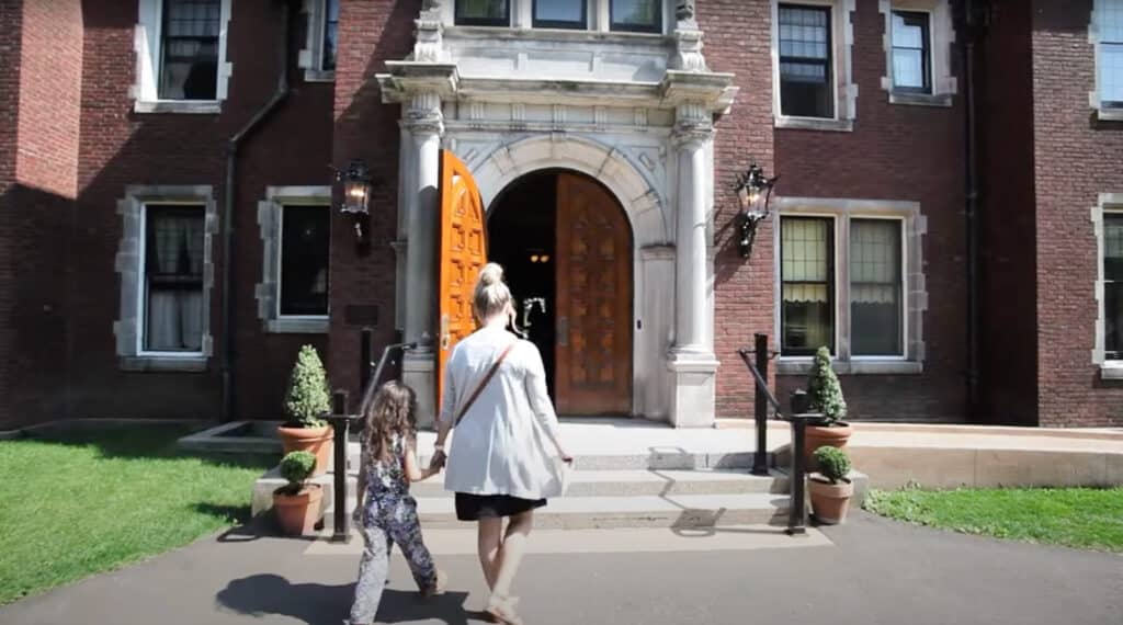A mother and daughter entering the doorway of The Glensheen Mansion in Duluth, Minnesota